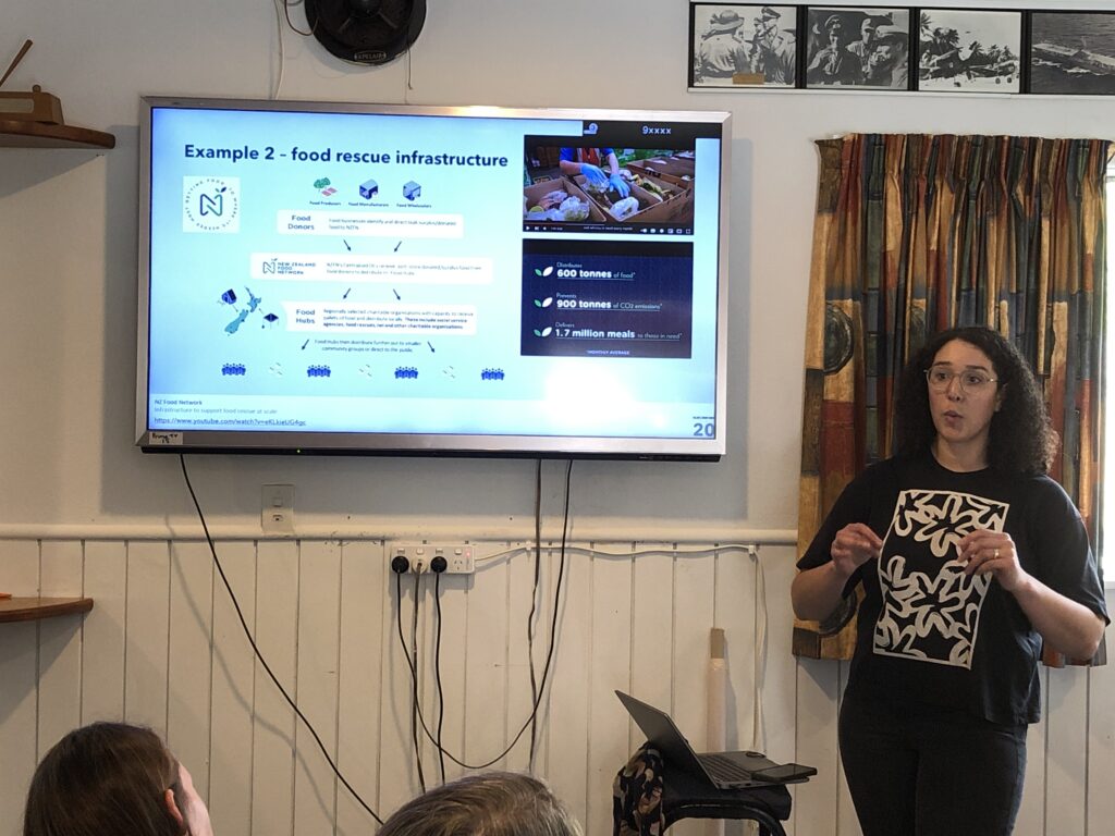 Photo of a woman presenting a slide show to a group of people