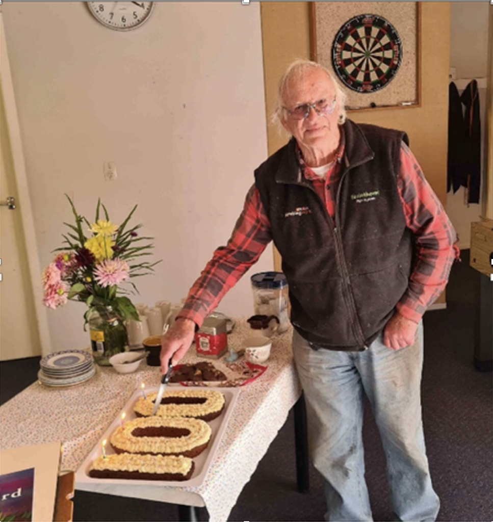 Mike Penney cutting the 100 years cake